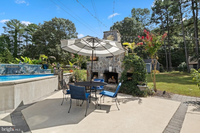 view of patio / terrace with an outdoor pool, an outdoor stone fireplace, fence, and outdoor dining area