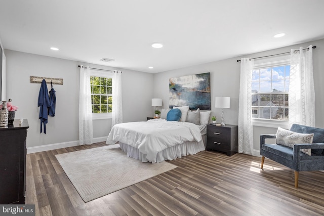 bedroom with dark hardwood / wood-style floors