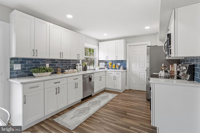 kitchen featuring white cabinetry, dark hardwood / wood-style floors, and appliances with stainless steel finishes