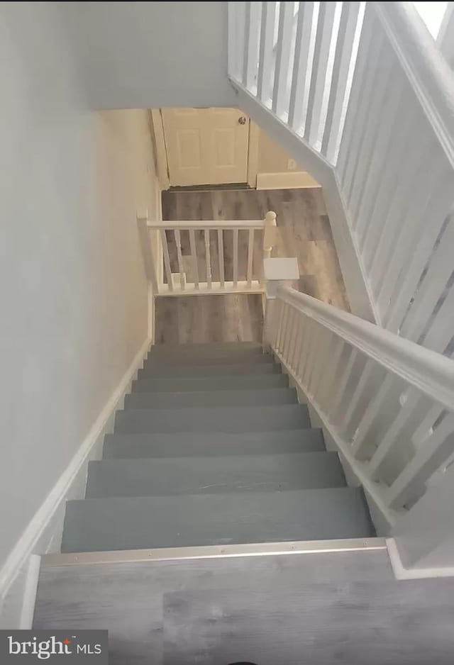 staircase with wood-type flooring