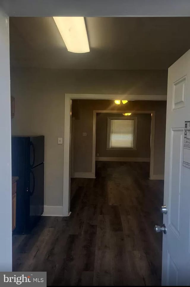 hallway with dark hardwood / wood-style floors