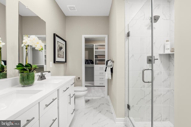 bathroom featuring toilet, double vanity, tile patterned floors, and an enclosed shower