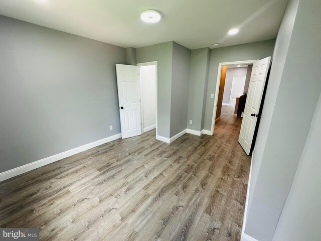 unfurnished bedroom featuring hardwood / wood-style flooring