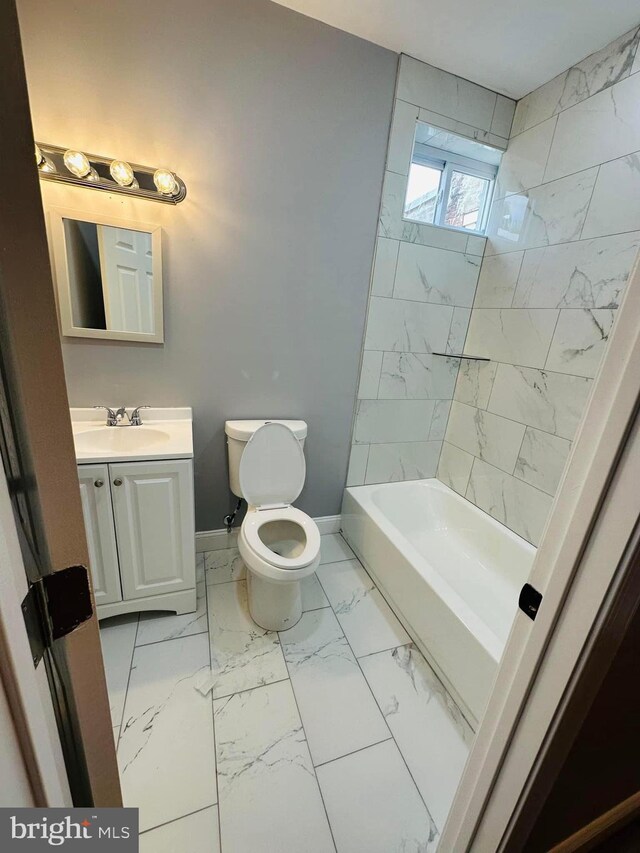 full bathroom featuring tiled shower / bath combo, vanity, tile patterned floors, and toilet