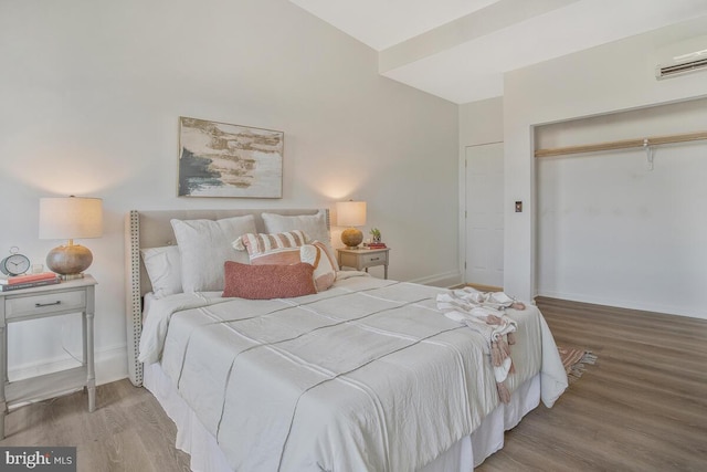 bedroom with light hardwood / wood-style flooring and a closet