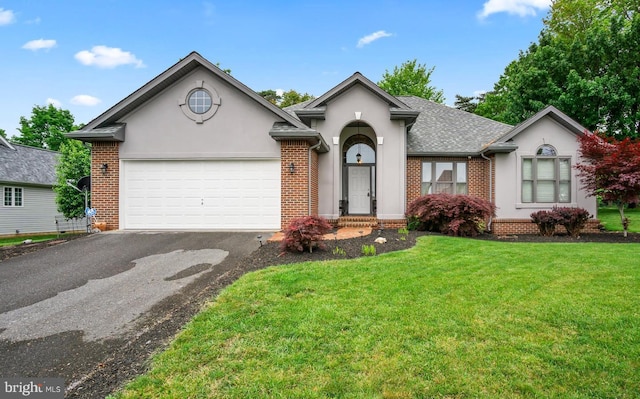 ranch-style home featuring a garage and a front yard