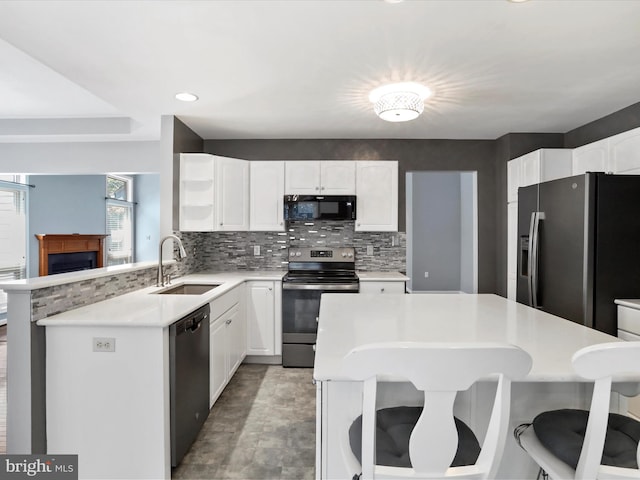 kitchen featuring white cabinetry, sink, backsplash, and appliances with stainless steel finishes