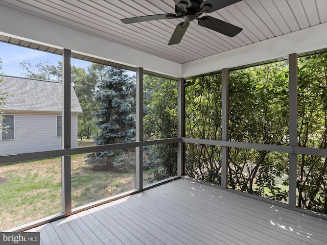 unfurnished sunroom featuring wooden ceiling and ceiling fan