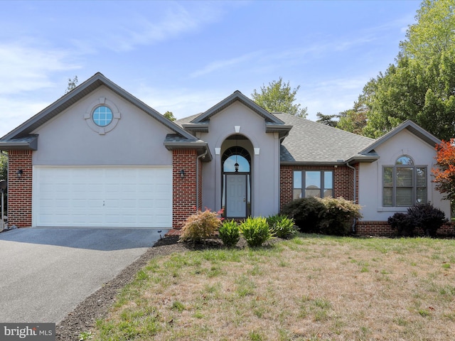 ranch-style home with a garage and a front yard