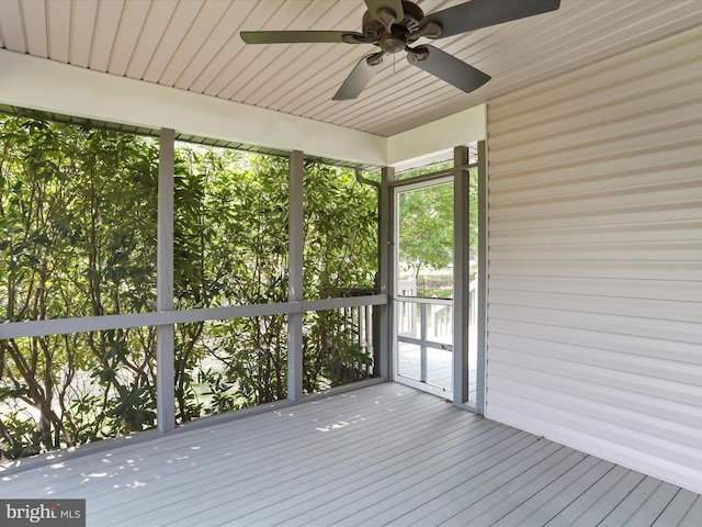 unfurnished sunroom featuring wooden ceiling and ceiling fan