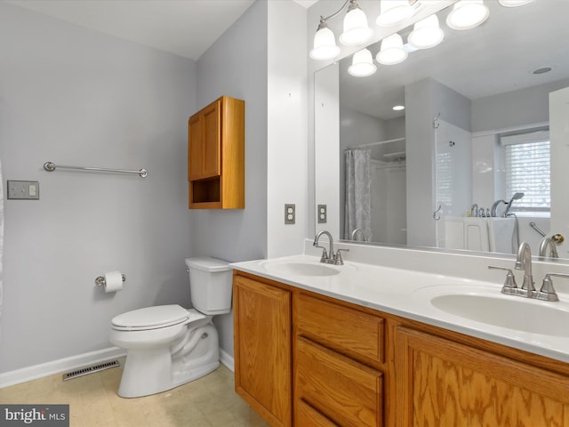 bathroom with curtained shower, vanity, and toilet