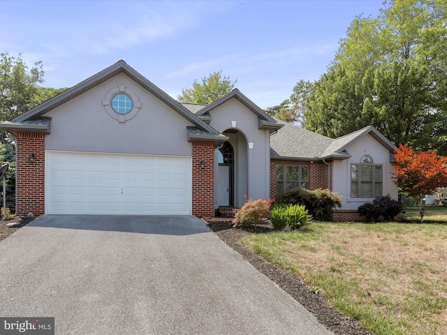 view of front facade with a garage and a front yard