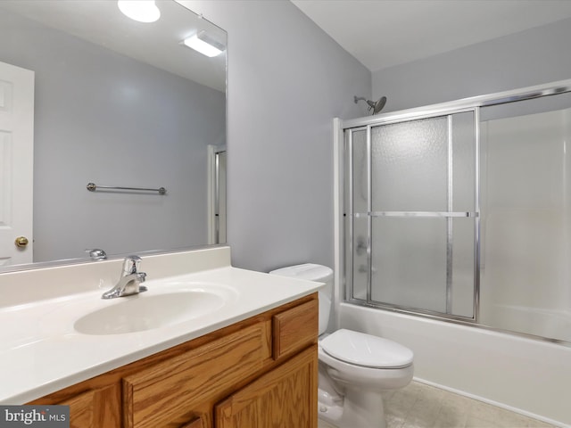 full bathroom with toilet, vanity, and bath / shower combo with glass door