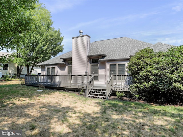 view of front of house with a deck and a front yard