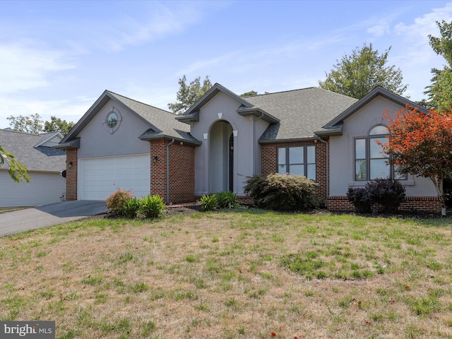 ranch-style home featuring a front lawn and a garage