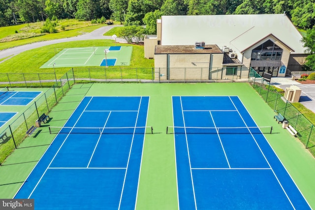 view of sport court featuring a lawn