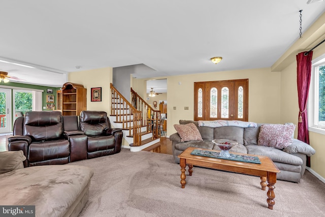 carpeted living room with ceiling fan