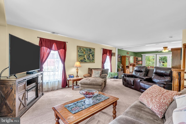 carpeted living room featuring ceiling fan