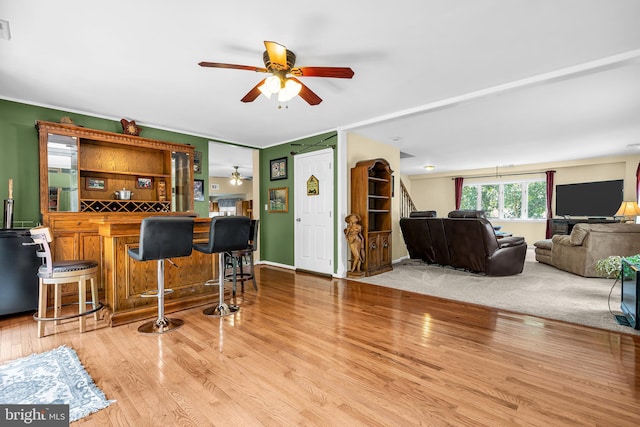 interior space with ceiling fan and light hardwood / wood-style flooring