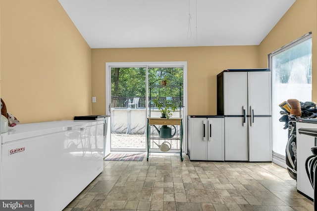 kitchen with white refrigerator and light tile patterned floors