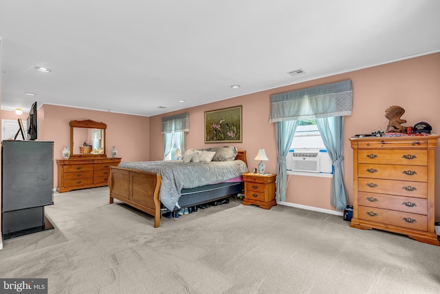 bedroom featuring light carpet and cooling unit