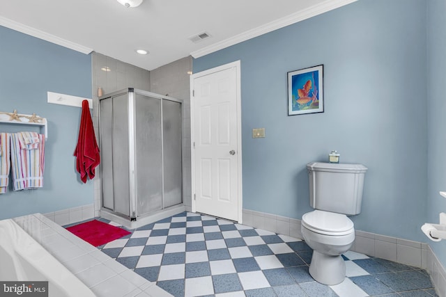 bathroom featuring tile patterned floors, toilet, a shower with door, and ornamental molding