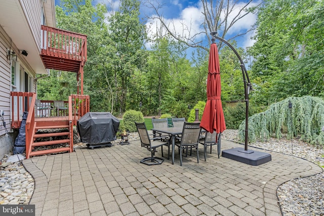 view of patio / terrace featuring a deck and a grill