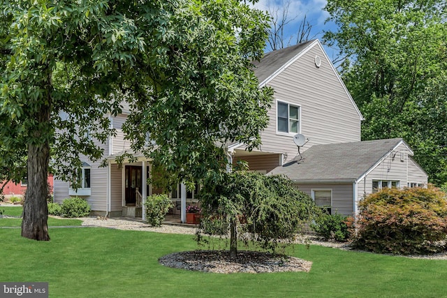 view of property hidden behind natural elements with a front yard