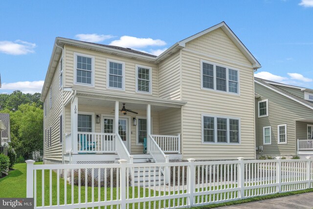 view of front facade featuring a front yard, ceiling fan, and covered porch