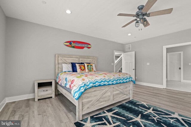 bedroom with hardwood / wood-style flooring and ceiling fan