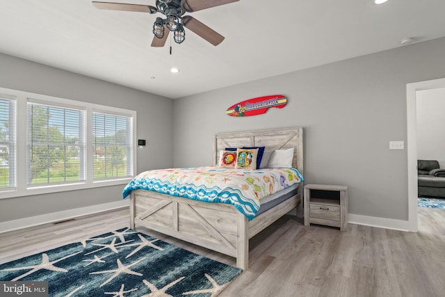 bedroom with hardwood / wood-style flooring and ceiling fan