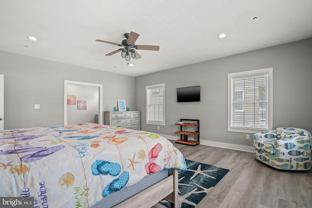 bedroom with light hardwood / wood-style floors and ceiling fan