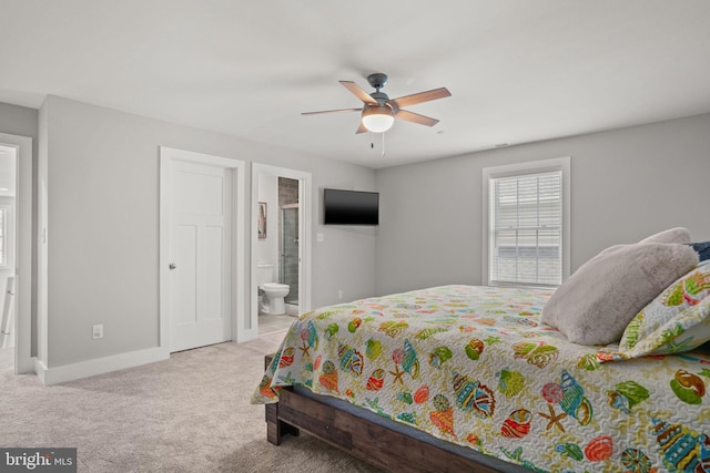 carpeted bedroom with ceiling fan and connected bathroom