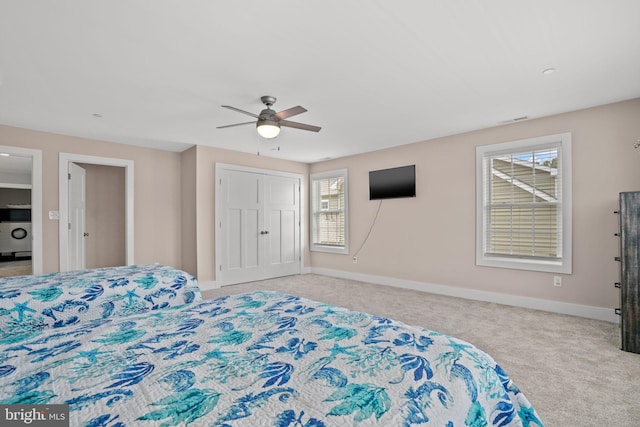 carpeted bedroom featuring ceiling fan and a closet