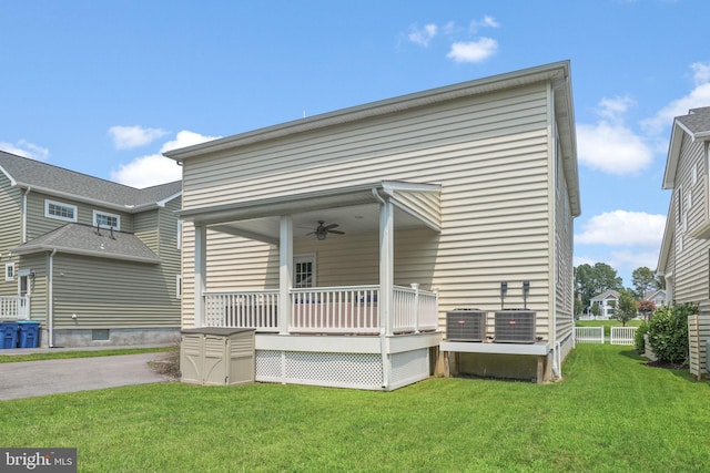 back of house with ceiling fan, a porch, a yard, and cooling unit