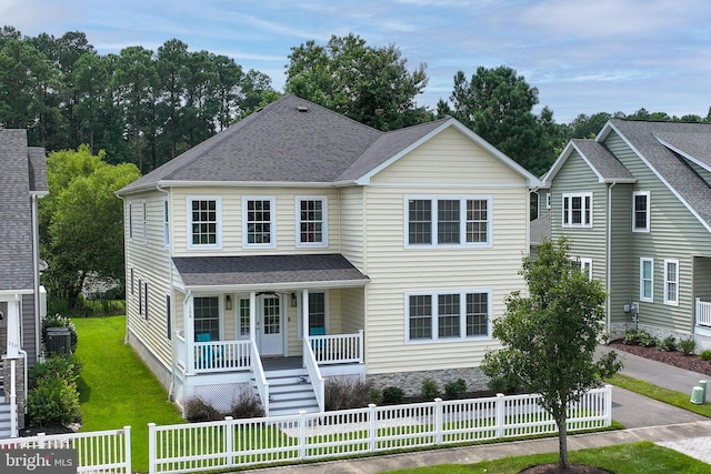 view of front of property with covered porch and a front lawn