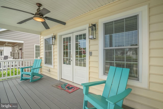 wooden terrace with french doors, ceiling fan, and a porch