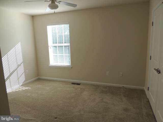 carpeted empty room with ceiling fan