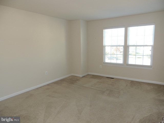 unfurnished room with light colored carpet