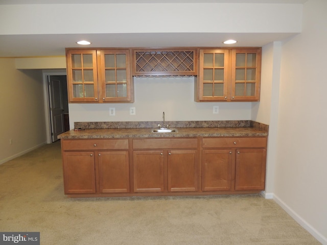 kitchen featuring light colored carpet and sink