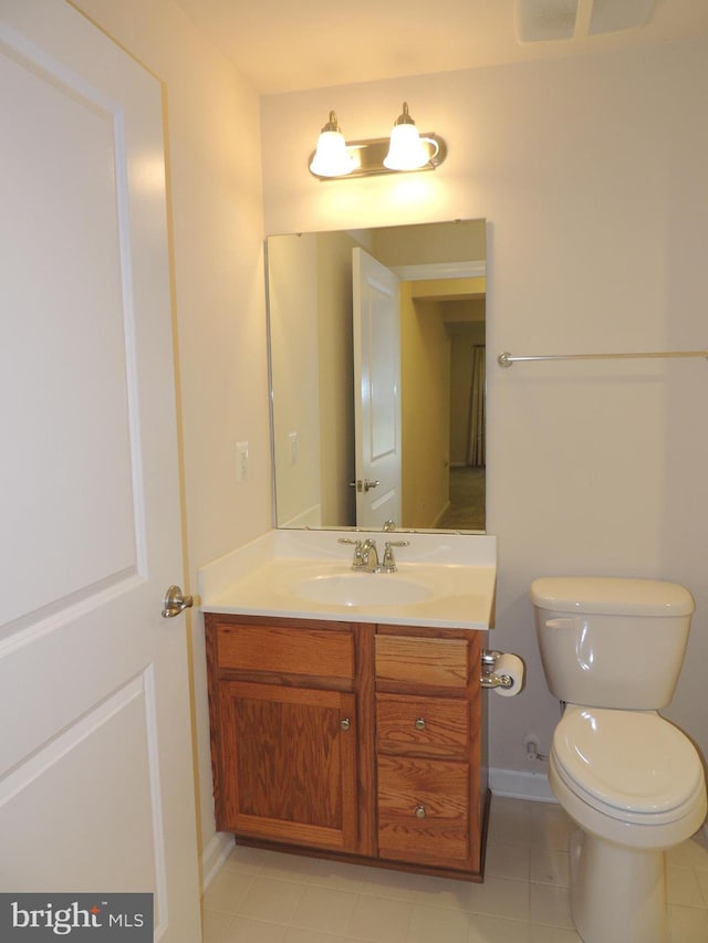 bathroom featuring tile patterned flooring, vanity, and toilet