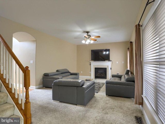 carpeted living room with ceiling fan