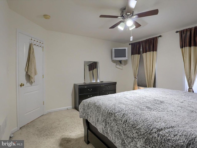 bedroom with ceiling fan and light colored carpet