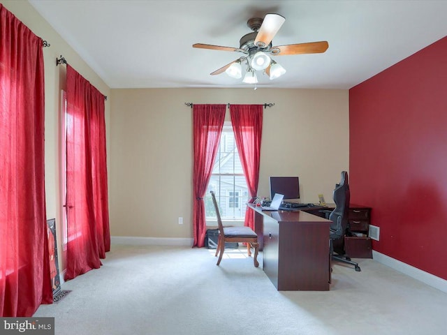 carpeted home office with ceiling fan