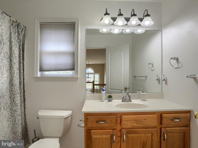 bathroom with toilet and vanity