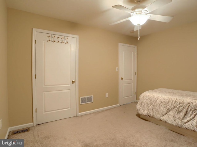 unfurnished bedroom with light colored carpet and ceiling fan