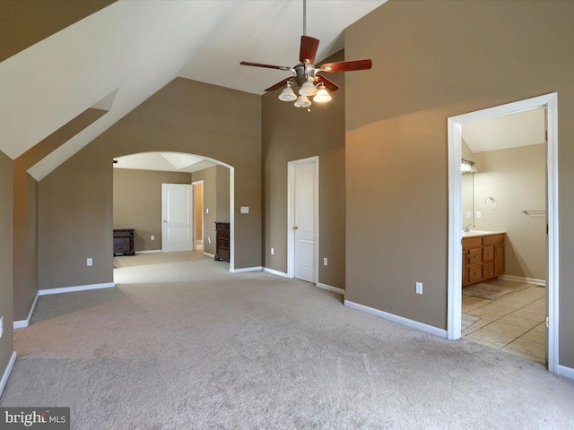 interior space with sink, ceiling fan, and vaulted ceiling