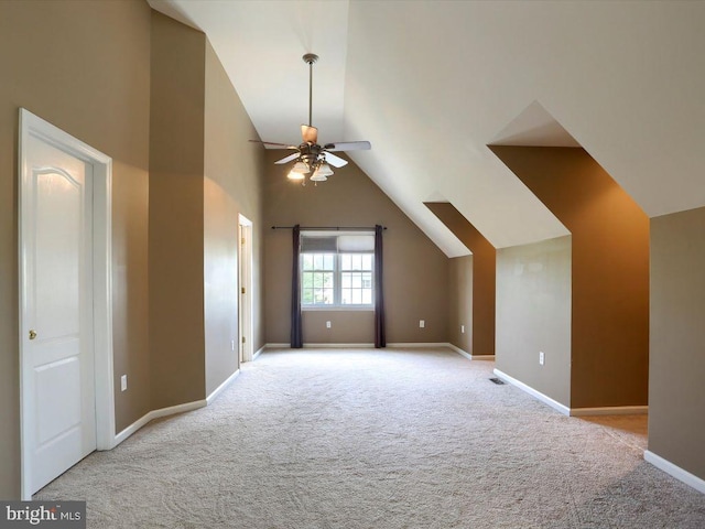 additional living space featuring light carpet, ceiling fan, and lofted ceiling