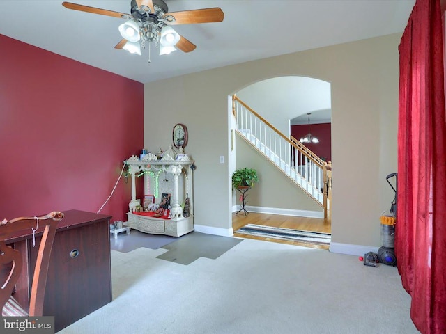 entrance foyer featuring ceiling fan with notable chandelier and hardwood / wood-style floors