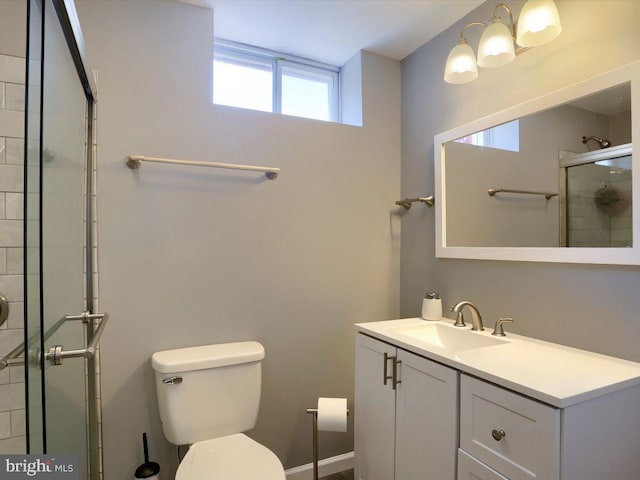 bathroom with vanity, walk in shower, and toilet